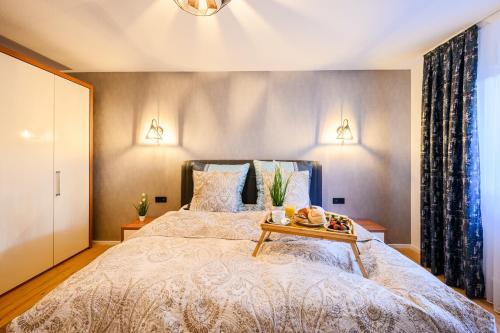 a bedroom with a bed with a tray of food on it at Loft 1453 in Ludwigshafen am Rhein