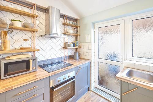 a kitchen with a sink and a microwave at Host & Stay - Friths in Scarborough