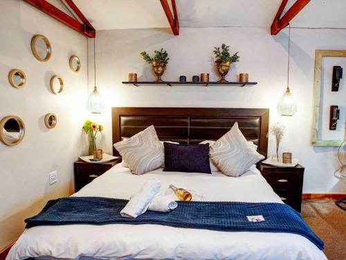a bedroom with a large bed with towels on it at Strand Guesthouse in Strand