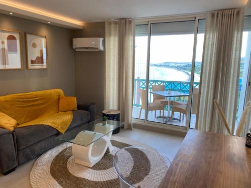 a living room with a couch and a table at Ocean SXM Studio in Cul de Sac