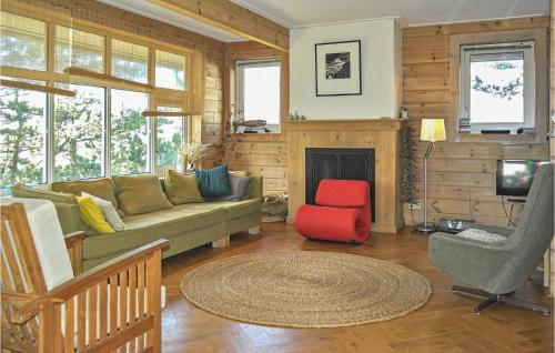 a living room with a green couch and a red chair at Finnhouse in Bergen aan Zee