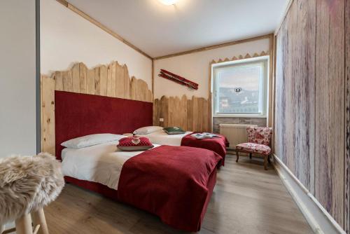 a hotel room with two beds and a window at Casa Ferrazza Michelle in Madonna di Campiglio