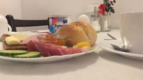 a plate of food with meat and vegetables on a table at Hotel Amelie Berlin in Berlin