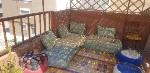 a couch and pillows on a balcony at Brothers House 1 in Imsouane