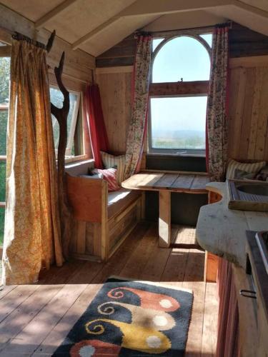 a room with a window and a table and a rug at Stunning 1-Bed Cabin in Totnes in Totnes