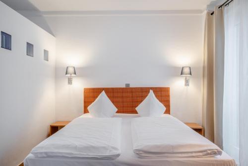 Ένα ή περισσότερα κρεβάτια σε δωμάτιο στο Hotel Schottenhof