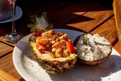 a white plate with food on a wooden table at PIER BEACH CLUB in Cabo Frio