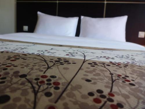 Détente Hôtelにあるベッド