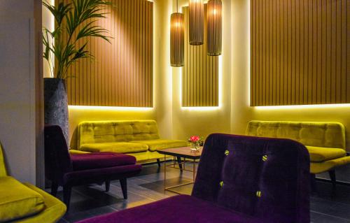 a living room with yellow couches and a table at Palazzo Navona Hotel in Rome