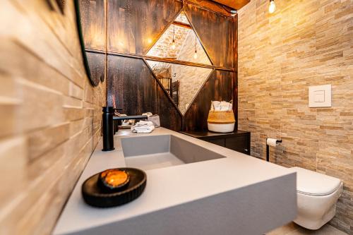 a bathroom with a sink and a toilet at Il Piccolo Borgo - Suite in Santeramo in Colle