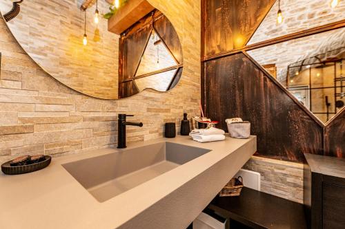 a bathroom with a large sink and a mirror at Il Piccolo Borgo - Suite in Santeramo in Colle