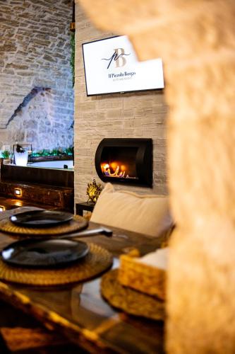 a table with plates of food on it with a fireplace at Il Piccolo Borgo - Suite in Santeramo in Colle