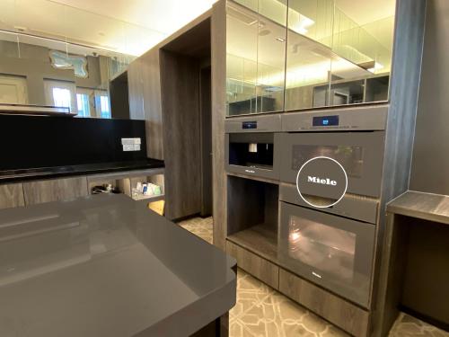 a kitchen with an oven and a tv in it at ST Signature Jalan Besar, DAYUSE, 5 Hours, 10AM-3PM in Singapore