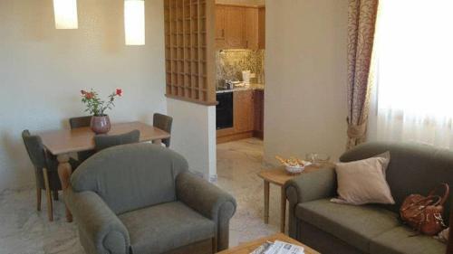 a living room with two couches and a table at Antella Residence in Bagno a Ripoli