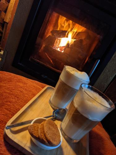 a tray with bread and glasses of water and a fireplace at Waard van Kekerdom in Kekerdom