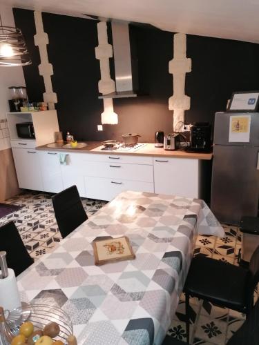 a kitchen with a table with a plate of fruit on it at Hôtes de l'Isle in Saint-Médard-de-Mussidan