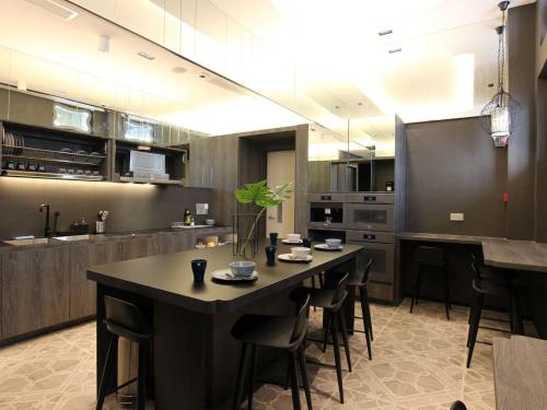 a large kitchen with a table and chairs in it at ST Signature Jalan Besar, SHORT OVERNIGHT, 13 Hours, 6PM-7AM in Singapore