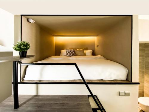 a bedroom with a large bed in a room at ST Signature Jalan Besar, SHORT OVERNIGHT, 13 Hours, 6PM-7AM in Singapore
