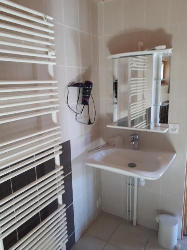 a bathroom with a sink and a mirror at La Michaille in Mijoux