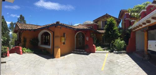 a house with a parking lot in front of it at INTIYAYA - Boutique Lodge in Otavalo
