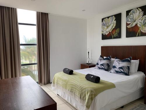 a bedroom with a bed and a large window at 202 Point bay in Durban