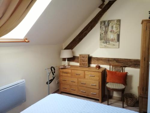 a bedroom with a bed and a dresser and a window at Beautiful 2-Bed House in Saint-Leger-Magnazeix in Saint-Léger-Magnazeix