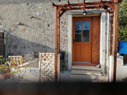 an entrance to a house with a wooden door at Beautiful 2-Bed House in Saint-Leger-Magnazeix in Saint-Léger-Magnazeix