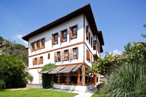 a large white building with wooden windows at Gulevi Safranbolu in Safranbolu