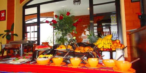 a buffet of fruits and vegetables on a table at Alisamay Hotel in Baños