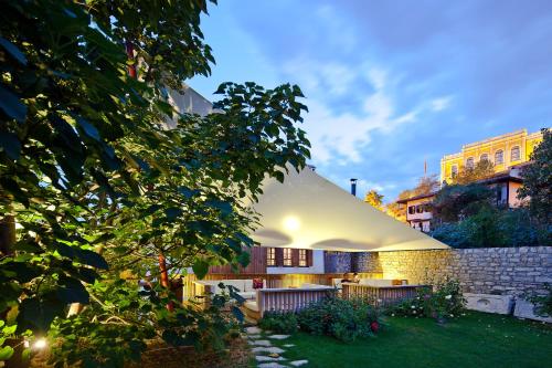 a house with a white roof and a yard at Gulevi Safranbolu in Safranbolu