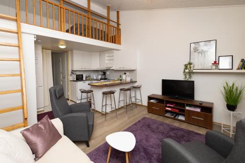 a living room with a couch and a table at Koivukuja Apartment in Vuokatti