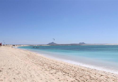 a view of a beach with blue water at African Sunset in Sal Rei