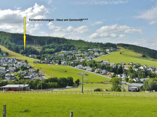 a small town on a hill with green grass at Quartier12 "Ski in & Bike out" - Fewo ZEIT in Willingen