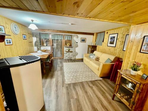 a kitchen and living room with a couch and a table at Chalet I Folletti in Abbadia San Salvatore
