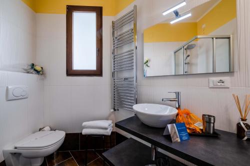 a bathroom with a sink and a toilet at AppartaHotel in Beinasco