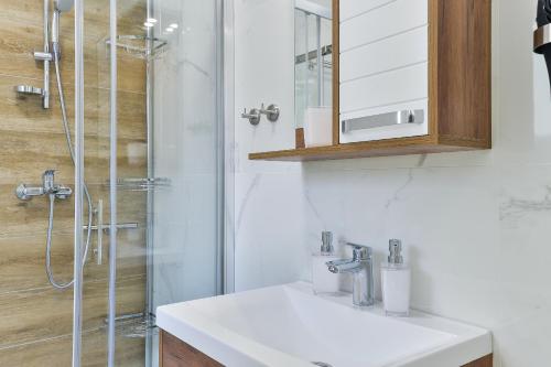 a bathroom with a sink and a shower at Cascada villas by Adex Travel in Starigrad-Paklenica