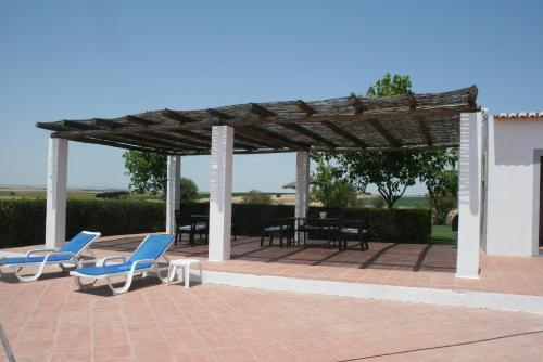 a pavilion with chairs and tables on a brick patio at Monte Da Morena Agro-Turismo in Serpa