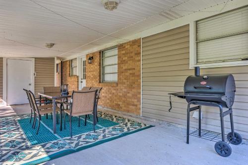 a patio with a grill and a table and chairs at Charming Gulfport Escape Half-Mile to Beach! in Gulfport