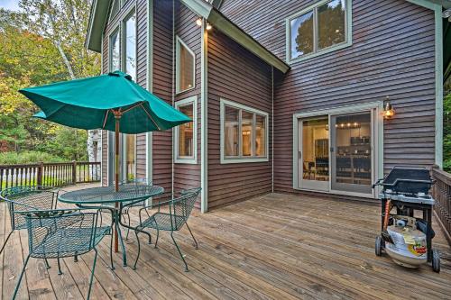 a patio with a table and chairs and an umbrella at Spacious Dover Refuge about 5 Mi to Mount Snow! in Dover