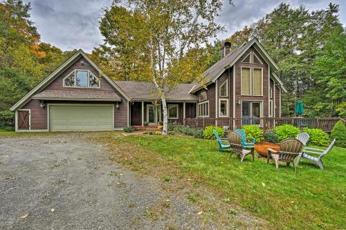a house with chairs sitting in the yard at Spacious Dover Refuge about 5 Mi to Mount Snow! in Dover
