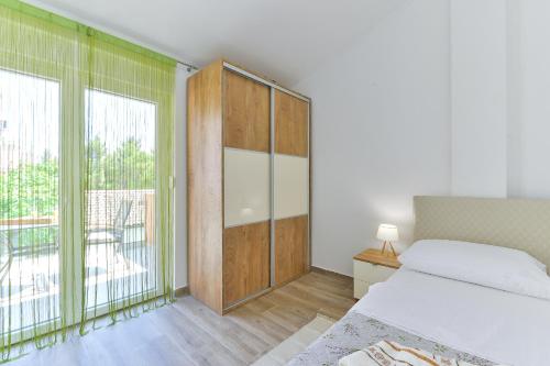 a bedroom with a bed and a large window at Cascada villas by Adex Travel in Starigrad-Paklenica