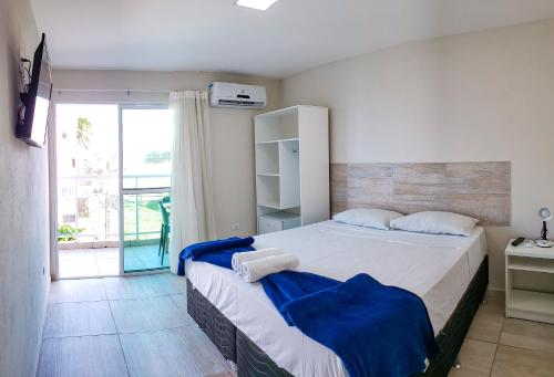 a bedroom with a large bed with blue sheets at Pousada Maresia Unique Beira Mar in Porto De Galinhas