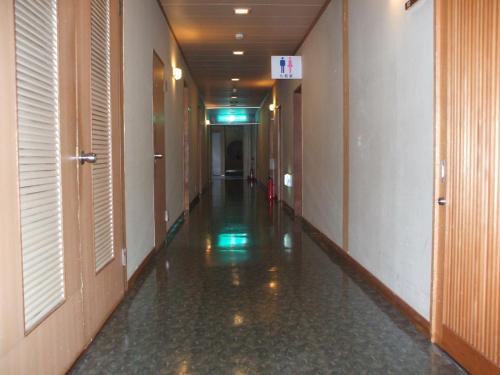 an empty hallway in a building with ailed floor at Annex Fujiya Ryokan in Kaminoyama