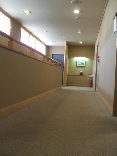 an empty hallway in an office building with a staircase at Annex Fujiya Ryokan in Kaminoyama