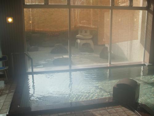 a pool of water with some birds in it at Annex Fujiya Ryokan in Kaminoyama