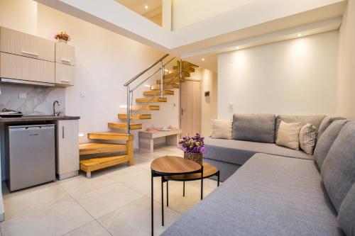 a living room with a couch and a table at Estian Deluxe in Limenaria