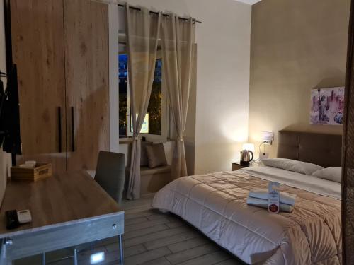 a bedroom with a large bed and a window at ESPOSITO PLAZA- ROOMS & SUITE in Naples