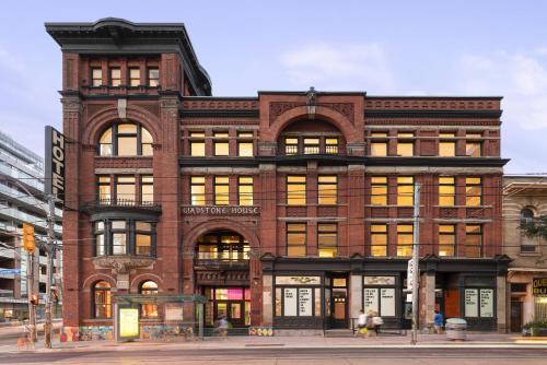 a large brick building on a city street at Gladstone House in Toronto