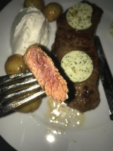 a plate of food with a piece of meat and eggs at Jeannette in Balingen