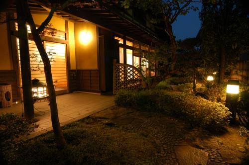 a house with a porch at night with lights at Bellino Hotel Ichinoseki in Ichinoseki